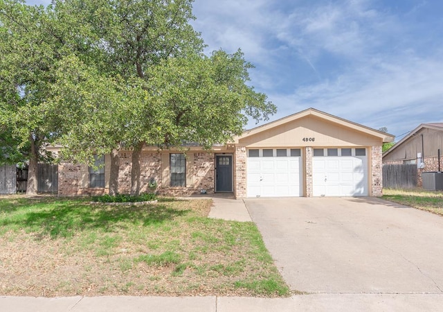 4906 San Antonio Ave, Midland, TX 79707 - single story home with an attached garage, brick siding, cooling unit, and driveway