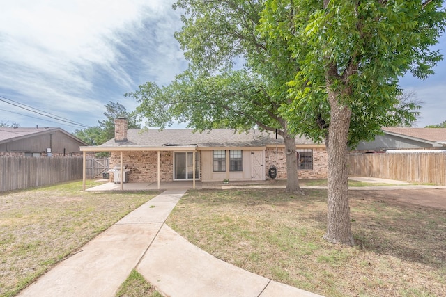 4906 San Antonio Ave, Midland, TX 79707 - view of front of house featuring a patio area and a chimney