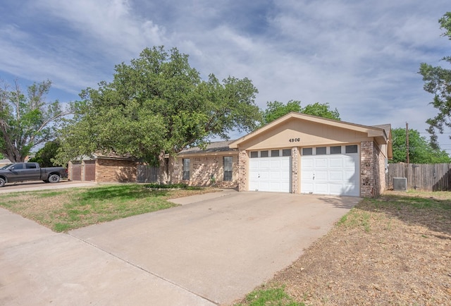 4906 San Antonio Ave, Midland, TX 79707 - ranch-style house featuring central air condition unit, a garage, brick siding, and driveway