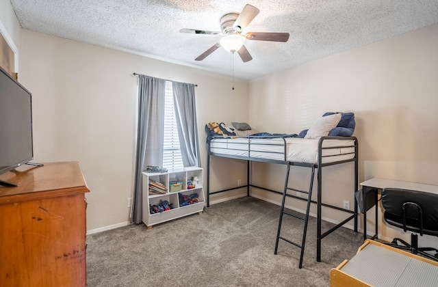 4906 San Antonio Ave, Midland, TX 79707 - bedroom featuring carpet, a textured ceiling, a ceiling fan, and baseboards