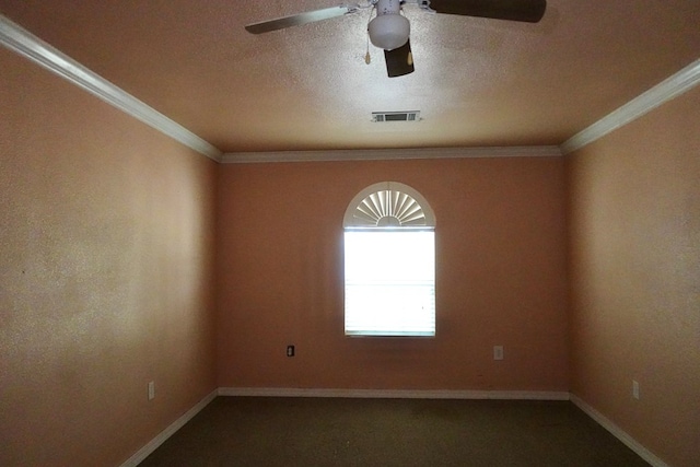 empty room with a ceiling fan, crown molding, carpet floors, and baseboards