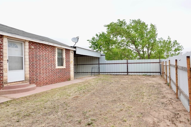 fenced backyard featuring entry steps