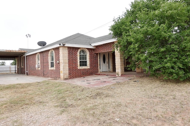 rear view of house with brick siding and a lawn