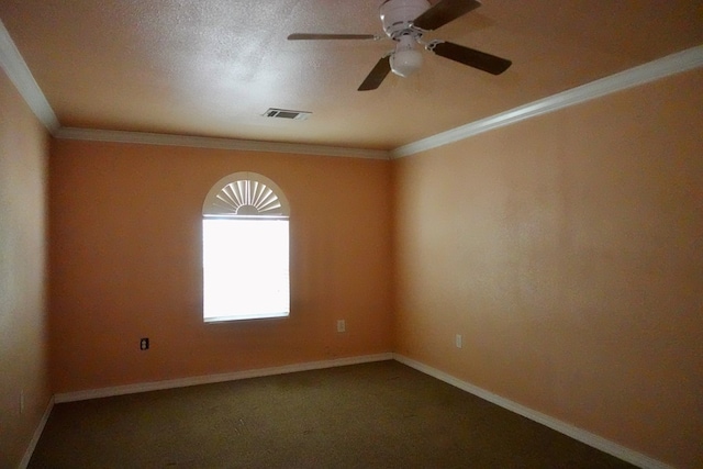 empty room with ceiling fan, baseboards, crown molding, and carpet