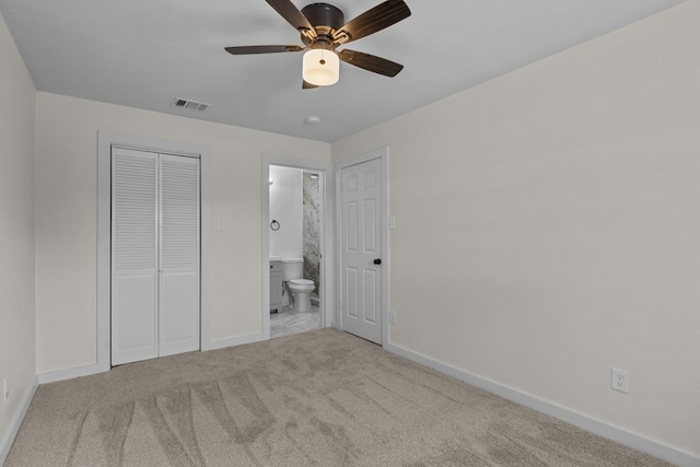 201 E Pine Ave, Midland, TX 79705 - unfurnished bedroom featuring a closet, baseboards, ensuite bathroom, visible vents, and carpet