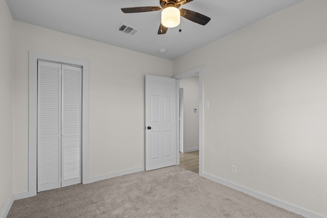201 E Pine Ave, Midland, TX 79705 - unfurnished bedroom featuring a closet, baseboards, carpet floors, visible vents, and ceiling fan