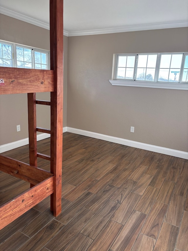 unfurnished room with ornamental molding and dark hardwood / wood-style flooring