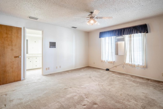 carpeted empty room with a textured ceiling and ceiling fan