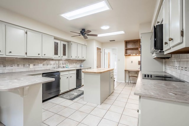 kitchen featuring dishwasher, white cabinets, decorative backsplash, black electric cooktop, and a kitchen island