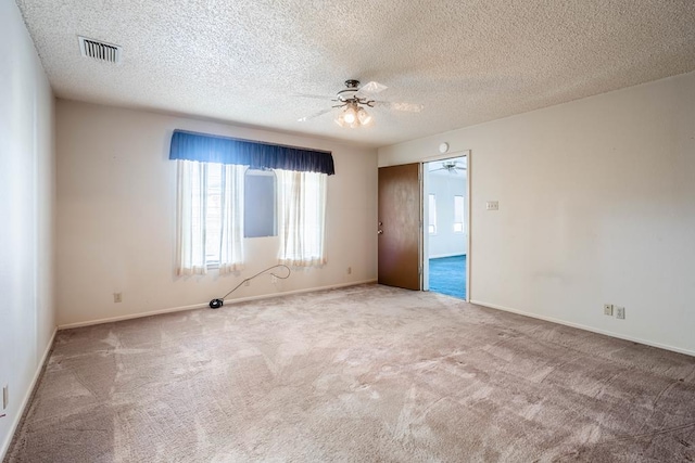 spare room featuring carpet flooring, a textured ceiling, and ceiling fan