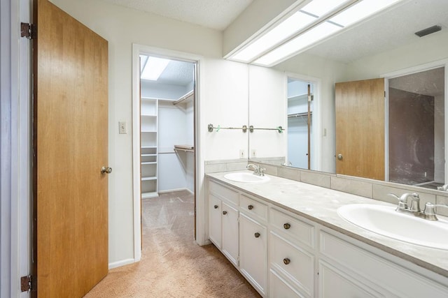 bathroom featuring vanity and a textured ceiling