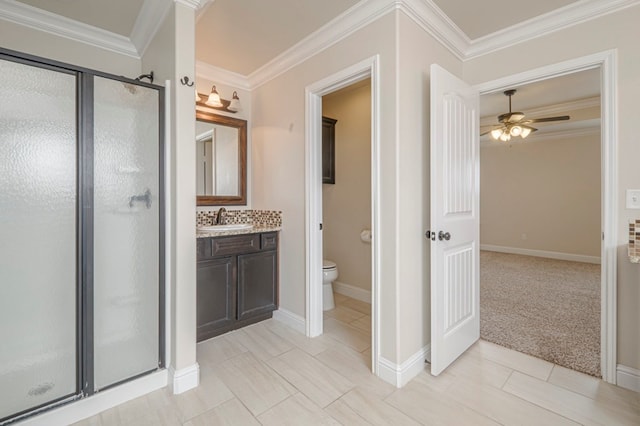 full bath featuring toilet, a stall shower, crown molding, and vanity