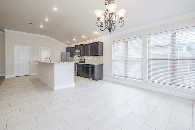 kitchen featuring light stone counters, crown molding, stainless steel appliances, vaulted ceiling, and baseboards