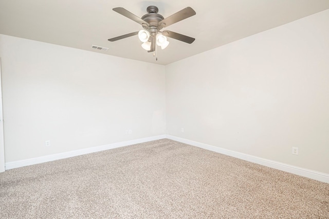 empty room featuring a ceiling fan, carpet, visible vents, and baseboards