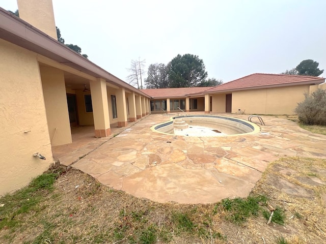 view of pool with a hot tub