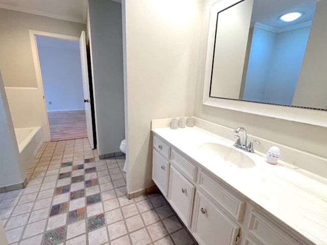 bathroom with ornamental molding, toilet, vanity, and a tub