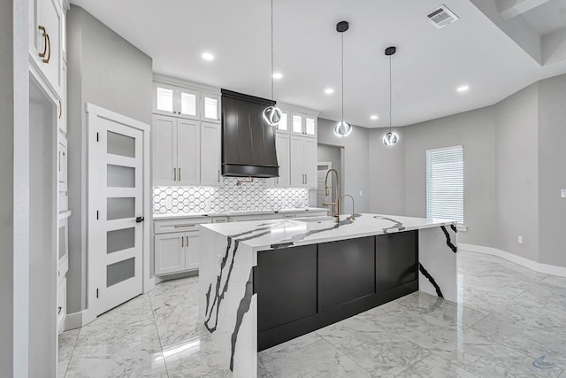 2102 S County Rd 1059, Midland, TX 79706 - kitchen with premium range hood, marble finish floor, visible vents, and a center island with sink