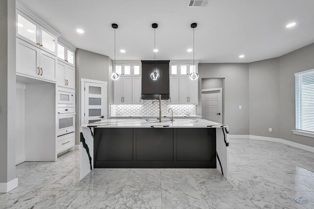 2102 S County Rd 1059, Midland, TX 79706 - kitchen with marble finish floor, a healthy amount of sunlight, baseboards, and white appliances