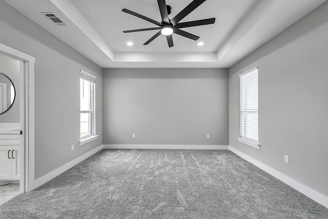 2102 S County Rd 1059, Midland, TX 79706 - empty room with carpet flooring, visible vents, ceiling fan, and a tray ceiling