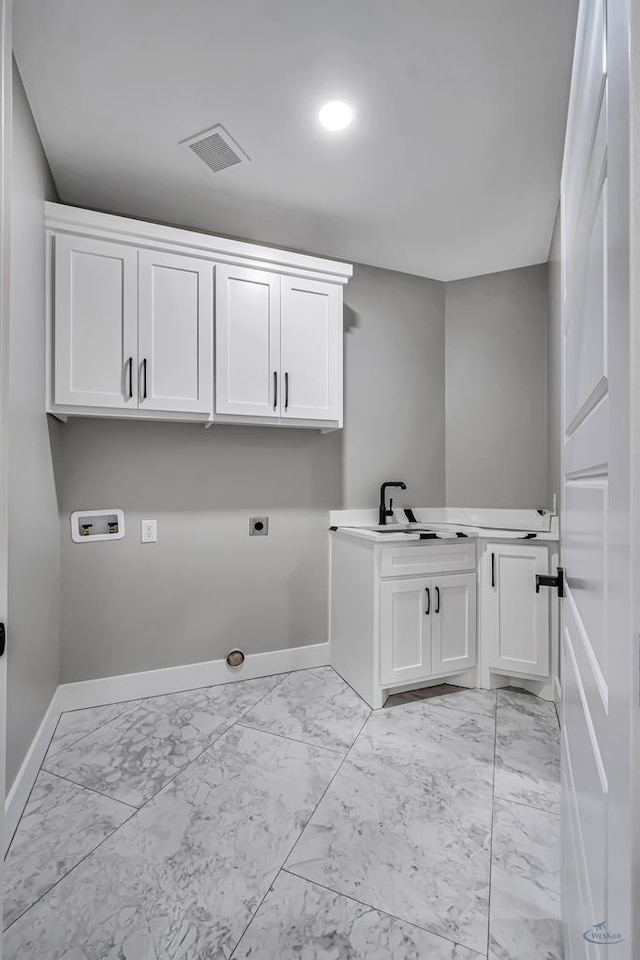 2102 S County Rd 1059, Midland, TX 79706 - laundry area with baseboards, cabinet space, electric dryer hookup, and marble finish floor