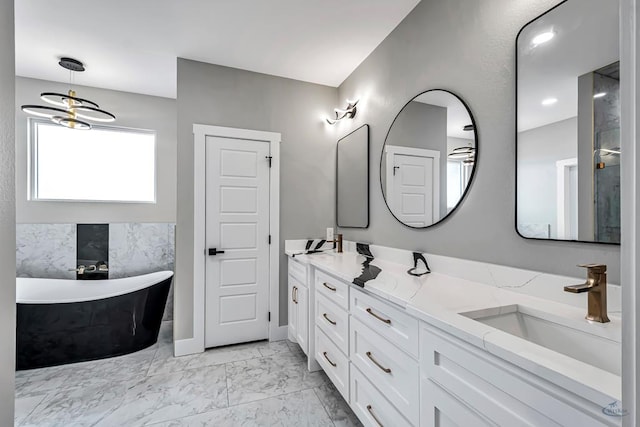 2102 S County Rd 1059, Midland, TX 79706 - bathroom featuring a freestanding tub, double vanity, marble finish floor, and a sink