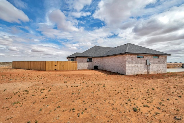 2102 S County Rd 1059, Midland, TX 79706 - rear view of house with fence, a gate, central AC unit, and brick siding