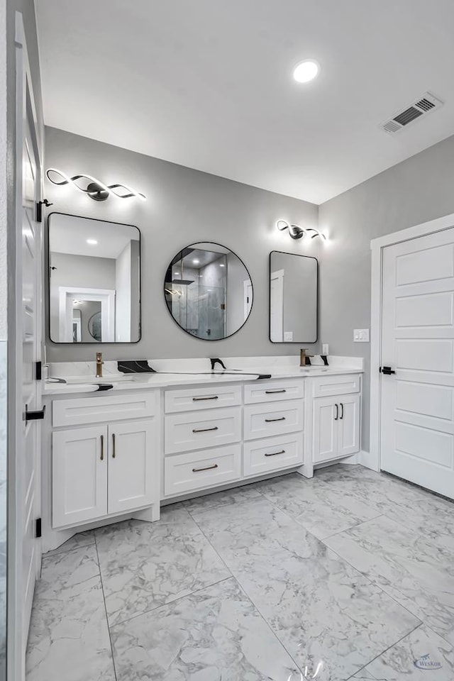 2102 S County Rd 1059, Midland, TX 79706 - bathroom featuring visible vents, double vanity, and marble finish floor