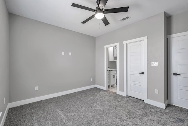 2102 S County Rd 1059, Midland, TX 79706 - unfurnished bedroom with carpet floors, ceiling fan, ensuite bathroom, baseboards, and visible vents
