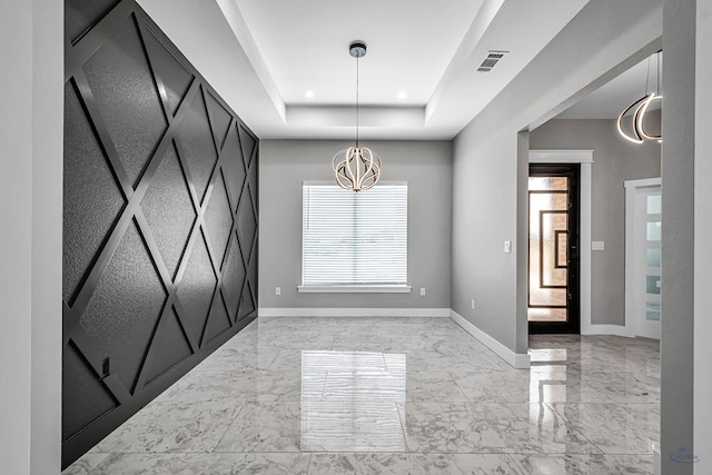 2102 S County Rd 1059, Midland, TX 79706 - spare room with an inviting chandelier, a tray ceiling, marble finish floor, visible vents, and baseboards