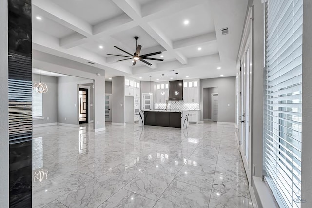 2102 S County Rd 1059, Midland, TX 79706 - unfurnished living room featuring coffered ceiling, recessed lighting, visible vents, and baseboards