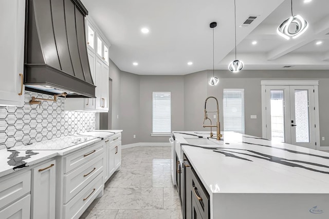 2102 S County Rd 1059, Midland, TX 79706 - kitchen with decorative backsplash, custom range hood, marble finish floor, visible vents, and an island with sink