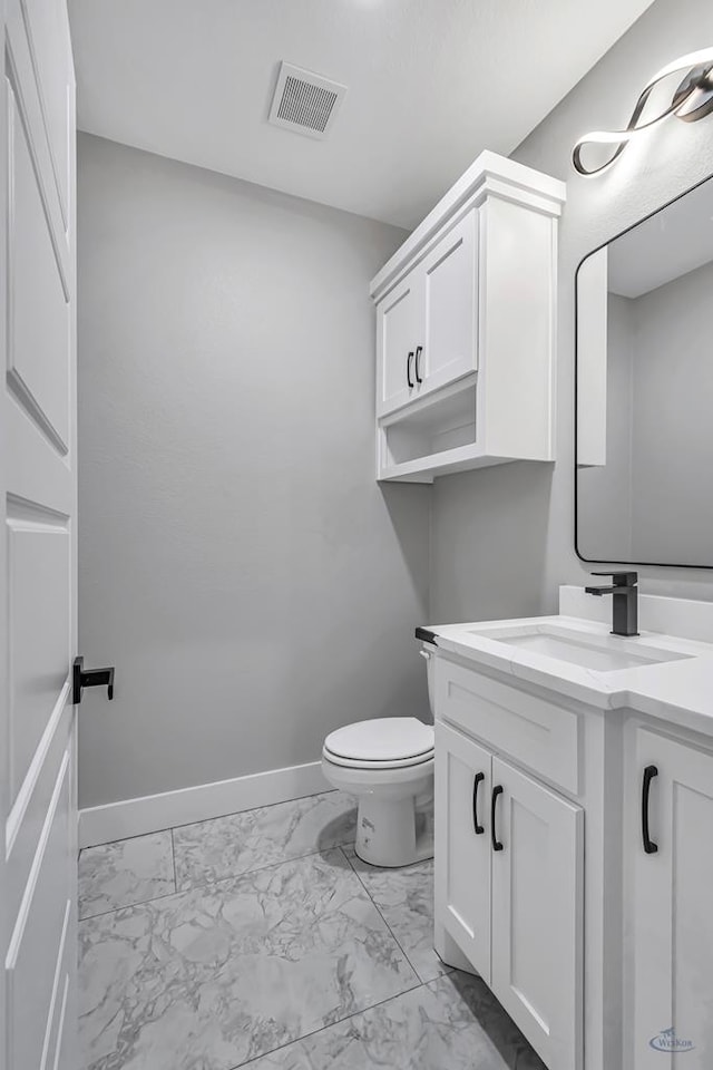 2102 S County Rd 1059, Midland, TX 79706 - bathroom featuring marble finish floor, toilet, vanity, baseboards, and visible vents