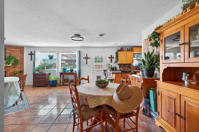 3811 Cimmaron Ave, Midland, TX 79707 - dining area with plenty of natural light and a textured ceiling