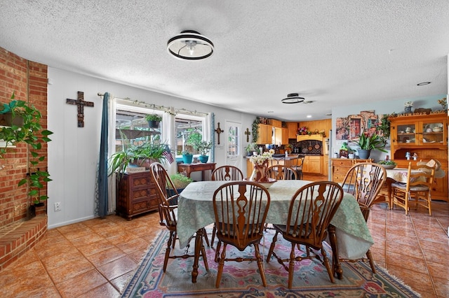 3811 Cimmaron Ave, Midland, TX 79707 - dining room featuring a textured ceiling and light tile patterned floors