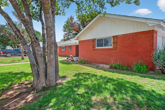 3811 Cimmaron Ave, Midland, TX 79707 - view of side of property featuring brick siding and a lawn