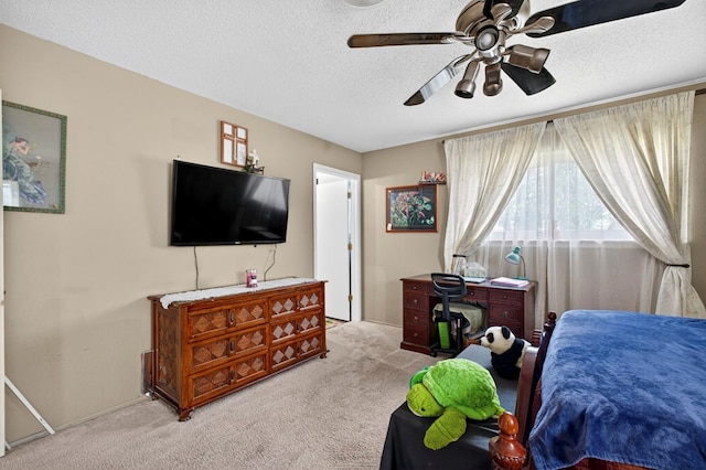 3811 Cimmaron Ave, Midland, TX 79707 - bedroom featuring light carpet, a textured ceiling, and a ceiling fan