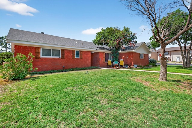 3811 Cimmaron Ave, Midland, TX 79707 - rear view of house featuring brick siding and a yard