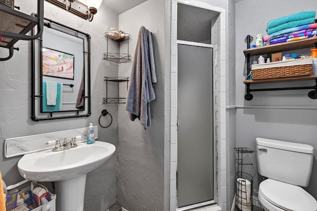 3811 Cimmaron Ave, Midland, TX 79707 - full bath featuring a stall shower, toilet, and a textured wall