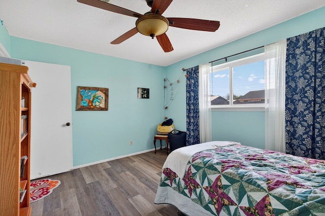 3811 Cimmaron Ave, Midland, TX 79707 - bedroom with wood finished floors, ceiling fan, and baseboards