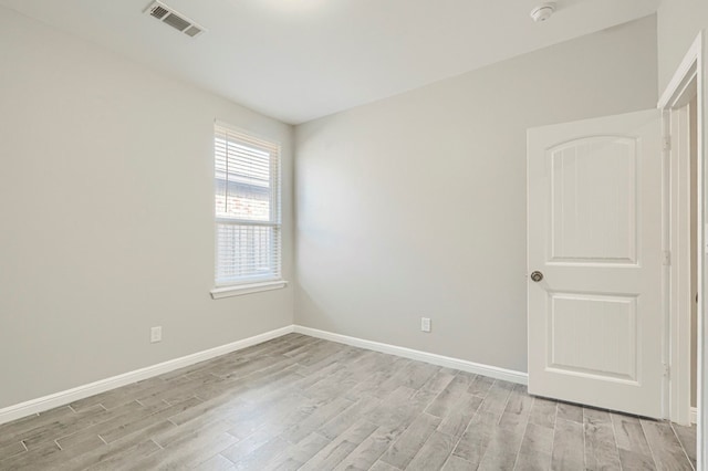 6913 Mcpherson Ln, Midland, TX 79706 - empty room with light wood-style floors, baseboards, and a smoke detector