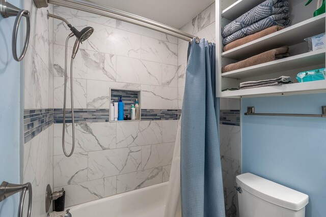 bathroom with shower / bath combo and toilet