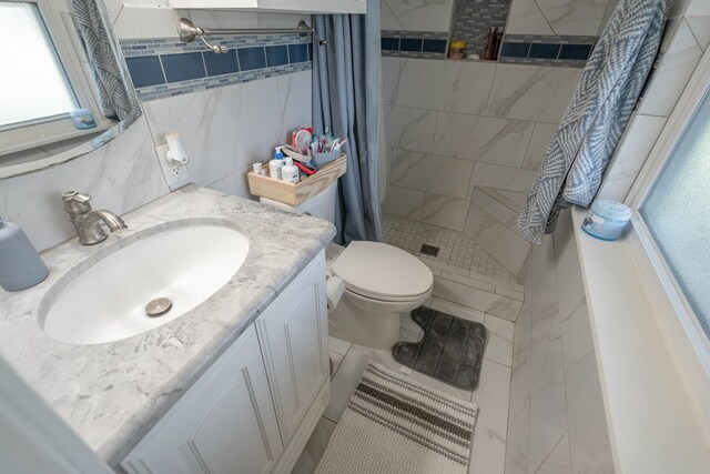 full bathroom with vanity, a stall shower, and toilet