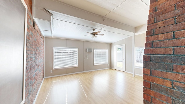 3304 Claremont Dr, Midland, TX 79707 - spare room with ceiling fan, wood finished floors, a wall mounted AC, brick wall, and baseboards