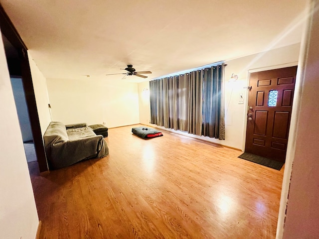 living room with hardwood / wood-style floors and ceiling fan