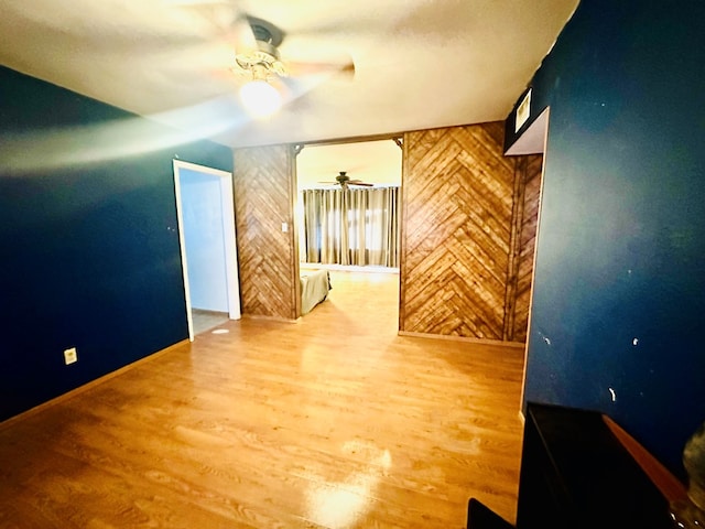 additional living space with wood-type flooring and ceiling fan