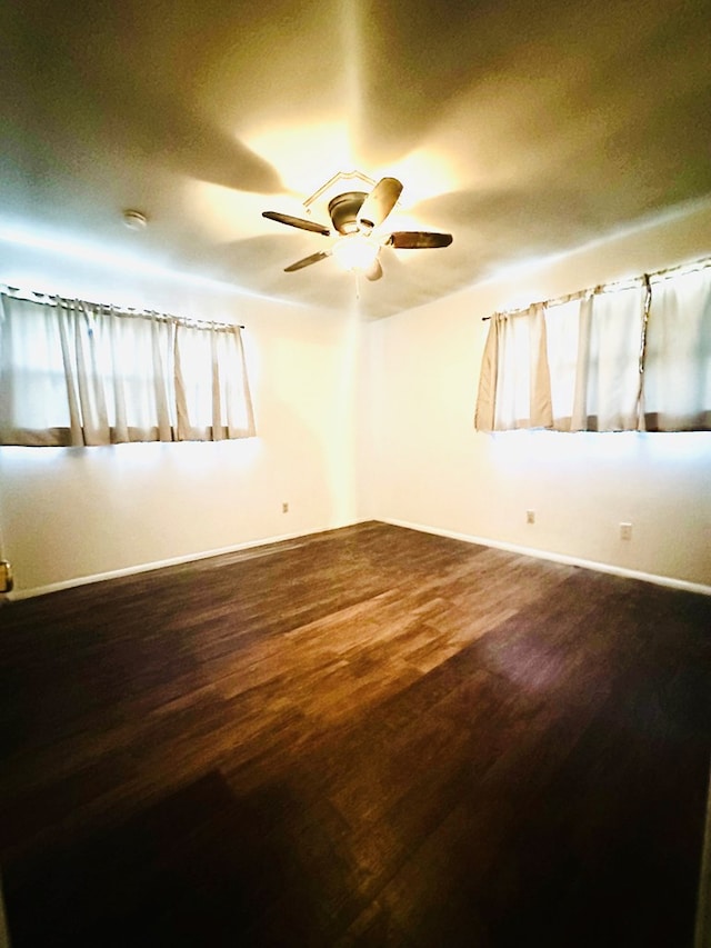 spare room with hardwood / wood-style floors and ceiling fan