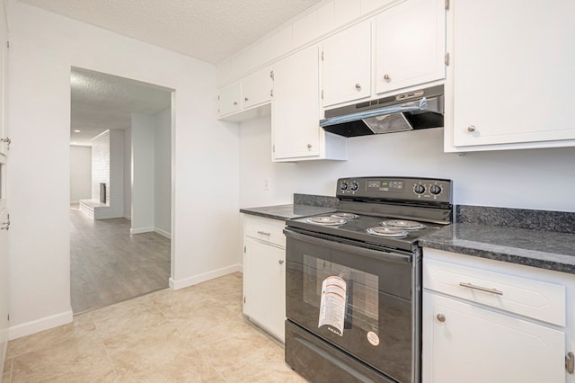 kitchen with black range with electric stovetop, white cabinets, and a textured ceiling