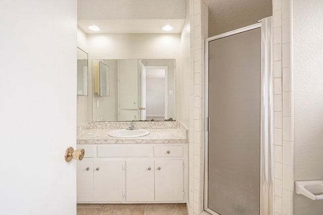 bathroom featuring tile patterned floors, vanity, and an enclosed shower