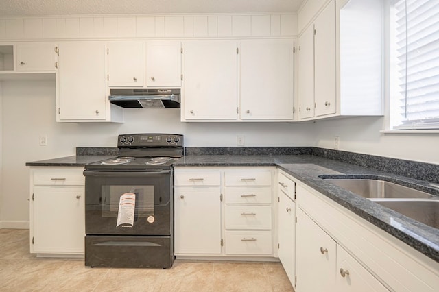 kitchen with white cabinetry, a textured ceiling, light tile patterned floors, electric range, and dark stone counters