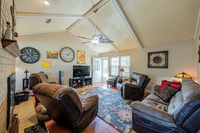 tiled living area featuring a fireplace, a textured ceiling, visible vents, ceiling fan, and vaulted ceiling with beams
